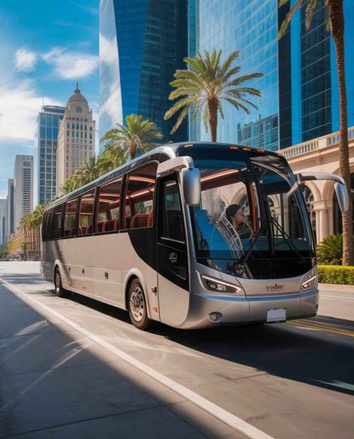 Modern luxury coach bus providing city to city bus transfer in Dubai on a clean highway with palm trees and skyscrapers in the background.